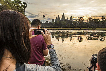 Tourists photographing the sunrise over the west entrance to Angkor Wat, Angkor, UNESCO World Heritage Site, Siem Reap, Cambodia, Indochina, Southeast Asia, Asia