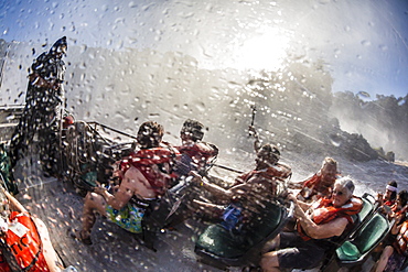 Tourists take a river boat to the base of the falls, Iguazu Falls National Park, UNESCO World Heritage Site, Misiones, Argentina, South America