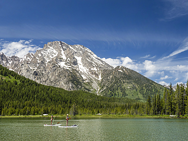 Stand up paddle boarders on String Lake, Grand Teton National Park, Wyoming, United States of America, North America