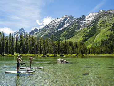 Stand up paddle boarders on String Lake, Grand Teton National Park, Wyoming, United States of America, North America