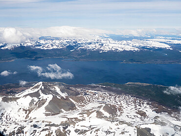 An aerial view of the snow-capped Andes Mountains surrounding the Beagle Channel, Argentina, South America