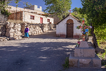 A small church and cross in the Chilean highland village of Caspana, Chile, South America