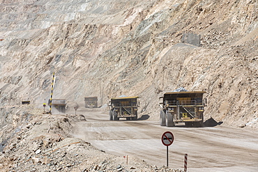 Huge dump trucks working the Chuquicamata open pit copper mine, the largest by volume in the world, Chile, South America