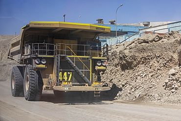 Huge dump trucks working the Chuquicamata open pit copper mine, the largest by volume in the world, Chile, South America