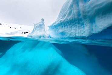 Above and below view of an iceberg at Cuverville Island, Ererra Channel, Antarctica, Polar Regions