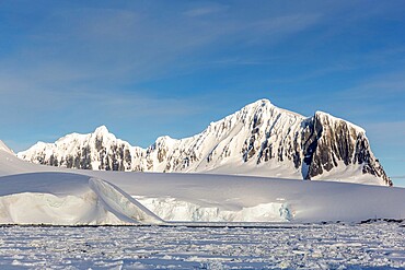 Snow-covered mountains and dense sea ice in Neumayer Channel, Palmer Archipelago, Antarctica, Polar Regions