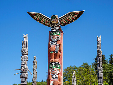 Kwakwaka'wakw totem poles in the cemetery in Alert Bay, Cormorant Island, British Columbia, Canada, North America