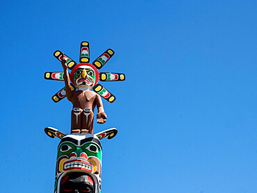 Kwakwaka'wakw totem poles in the cemetery in Alert Bay, Cormorant Island, British Columbia, Canada, North America