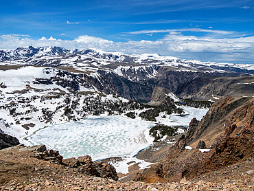 Snow-capped mountains and a frozen lake near Beartooth Pass, Wyoming, United States of America, North America