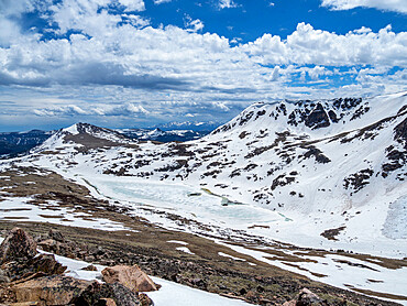 Snow-capped mountains and a frozen lake near Beartooth Pass, Wyoming, United States of America, North America