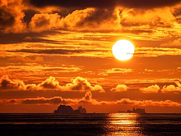 Sunset on a large iceberg at sea towards Peter I Island, Bellingshausen Sea, Antarctica, Polar Regions