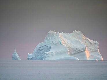 Sunset on a large iceberg at sea towards Peter I Island, Bellingshausen Sea, Antarctica, Polar Regions