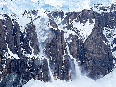 Snow falling in an avalanche on Brabant Island, Antarctica, Polar Regions