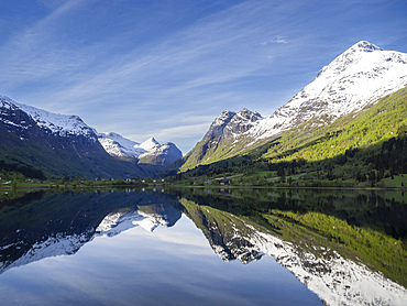 A view of snow-covered mountains and reflections in Lake Oldevatnet, within the Oldedalen River Valley, Vestland, Norway, Scandinavia, Europe