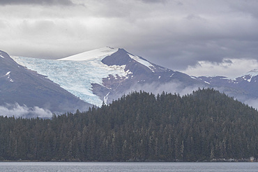 A hanging glacier surrounded by the Tongass National Forest, Behm Canal, Southeast Alaska, USA.