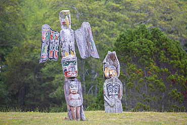 Kwakwaka'wakw totem poles in the cemetery in Alert Bay, Cormorant Island, British Columba, Canada.