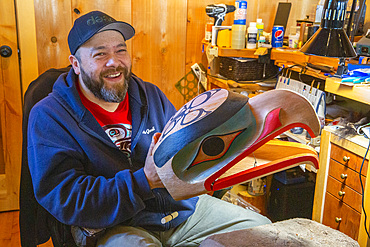 Artisan with traditional mask in Old Massett, G̱aaw in X̱aad kíl, Graham Island, Haida Gwaii, British Columbia.