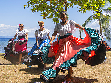 A group of young Costa Rican dancers in traditional dress perform at Playa Blanca, El Golfito, Costa Rica, Central America