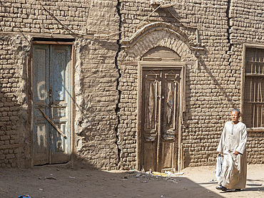 An Egyptian vwalking along the street in the heart of the city of Dendera, Egypt, North Africa, Africa