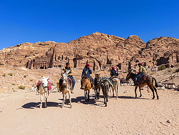 Donkeys and riders, Petra Archaeological Park, UNESCO World Heritage Site, one of the New Seven Wonders of the World, Petra, Jordan, Middle East