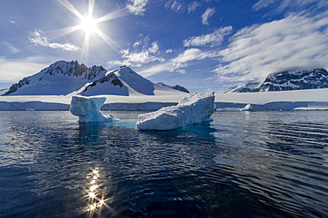 View of calm seas and reflected mountains surrounding Damoy Point in Dorian Bay, Antarctica, Polar Regions