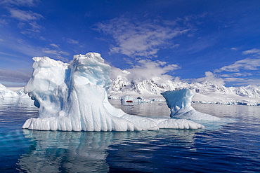 View of calm seas and icebergs with reflected mountains surrounding Damoy Point in Dorian Bay, Antarctica, Polar Regions