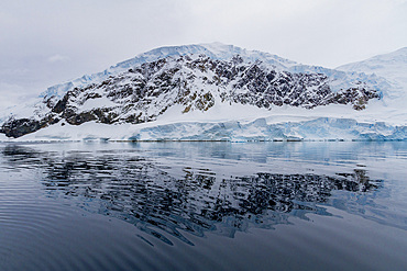 View of calm seas and reflected mountains surrounding Neko Harbor on the western side of the Antarctic Peninsula, Polar Regions