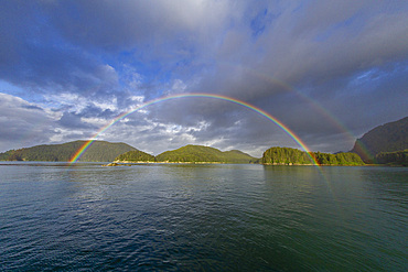 Complete rainbow over the calm waters of Inian Pass in southeast Alaska, Pacific Ocean, United States of America, North America