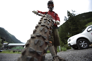 Man holding his mountainbike, Ischgl, Tyrol, Austria