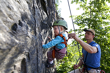 Boy (2 years) climbing in a quarry, Leipzig, Saxony, Germany