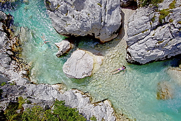 Two young women bathing in the river Soca, Alpe-Adria-Trail, Tolmin, Slovenia