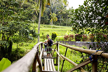 Woman passing a bamboo bridge, Karangasem, Bali, Indonesia