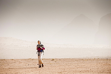 Woman hiking through desert scenery, Wadi Rum, Jordan, Middle East