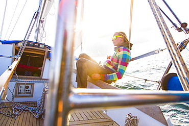 Woman on a sailing boat in sunset, Istria, Croatia