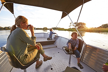 Family having a boat trip on the Kunene River, Kaokoland, Namibia