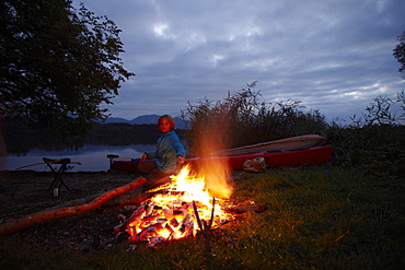 Boy at bonfire, lake Staffelsee, Seehausen, Upper Bavaria, Germany