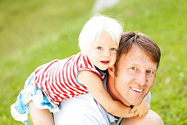 two-year-old girl on her father's back, Speyer, Rheinland-Pfalz, Germany