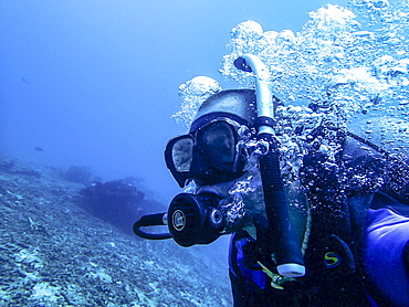 Diver breathing out with air bubbles - Indonesia, Java