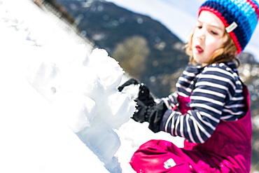 boy forming snowballs in winter, Pfronten, Allgaeu, Bavaria, Germany