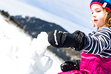 boy forming snowballs in winter, Pfronten, Allgaeu, Bavaria, Germany