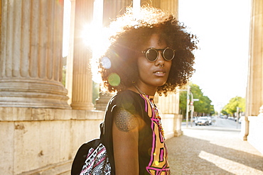 Young afro-american woman in backlight scenery at Koenigsplatz, Munich, Bavaria, Germany