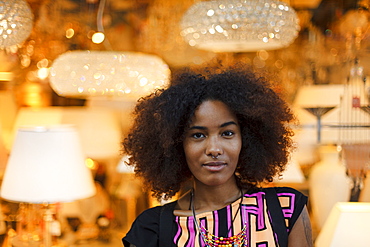 Portrait of a young afro-american woman in front of lamps, Munich, Bavaria, Germany