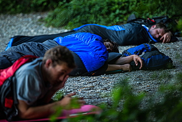 Three young men camping at a lake, Freilassing, Bavaria, Germany