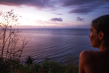 Young woman enjoying the view towards the sea at sunset, Sao Tome, Sao Tome and Principe, Africa