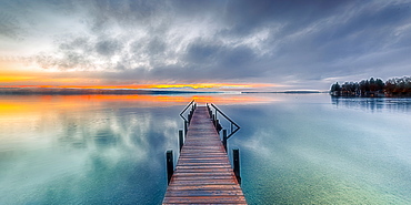 Jetty at sunrise on Lake Starnberg, Bavaria, Germany