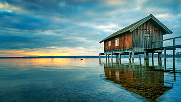 Boathouse at sunset on Ammersee, Stegen, Bavaria, Germany