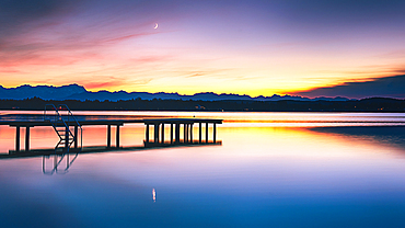 Jetty on Lake Starnberg at sunset with a view of the mountains, St. Heinrich, Bavaria, Germany