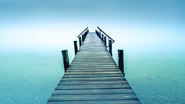 Jetty in the fog at Lake Starnberg, Garatshausen, Bavaria, Germany