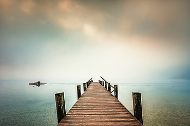 Jetty in the fog at Lake Starnberg, Garatshausen, Bavaria, Germany