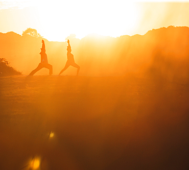 Two women doing yoga on the beach in the morning light, yoga, beach, Portugal